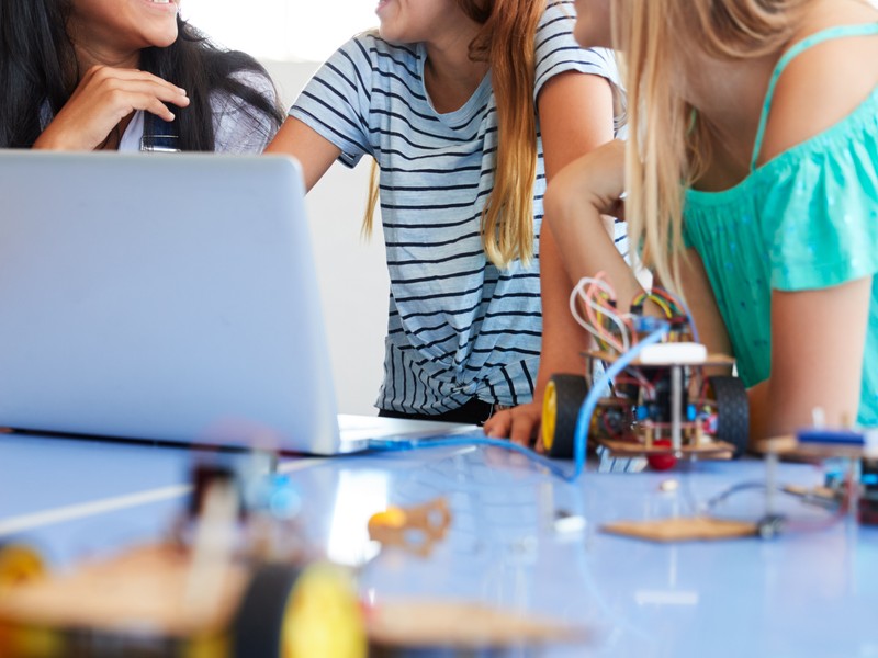 Young students learning German during a coding class after school