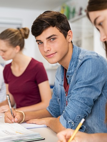 Young students learning German during a coding class after school