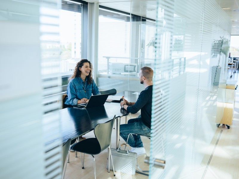 Professional taking a German language lesson at the office with a private language coach