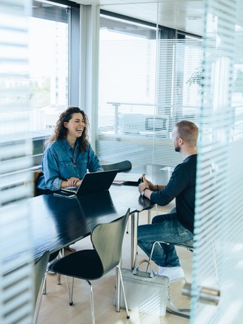 Professional taking a German language lesson at the office with a private language coach