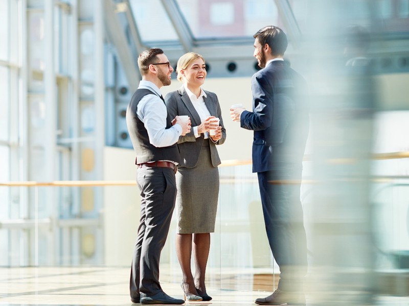 Business colleagues chatting during coffee break after a German training class