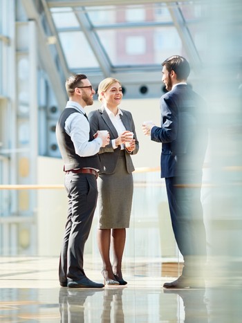 Business colleagues chatting during coffee break after a German training class