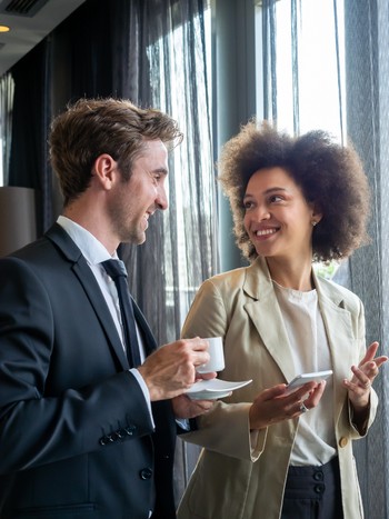 Business colleagues talking together after a German language course at the office