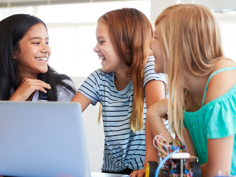 Young students learning German during a coding class after school