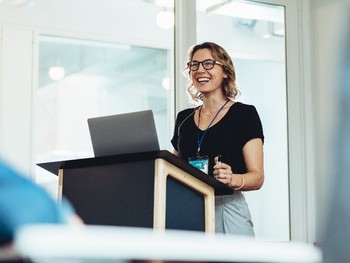 Businesswoman making a presentation in German at a seminar